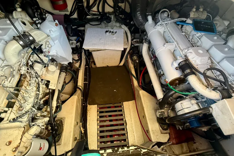 Slide: The Image of Engine room of a 1998 Tiara Yachts 3500 Express, showcasing dual engines and mechanical components. - 36