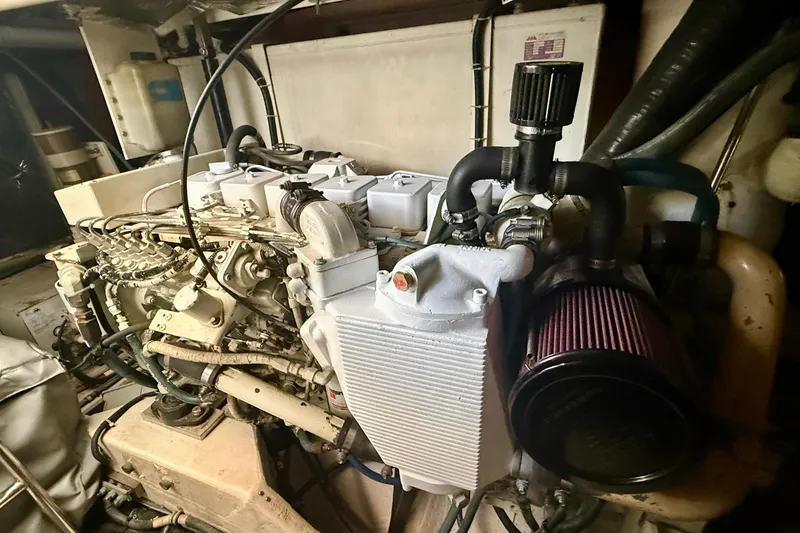 Slide: The Image of Engine compartment of a 1998 Tiara Yachts 3500 Express, showcasing mechanical components and hoses. - 37