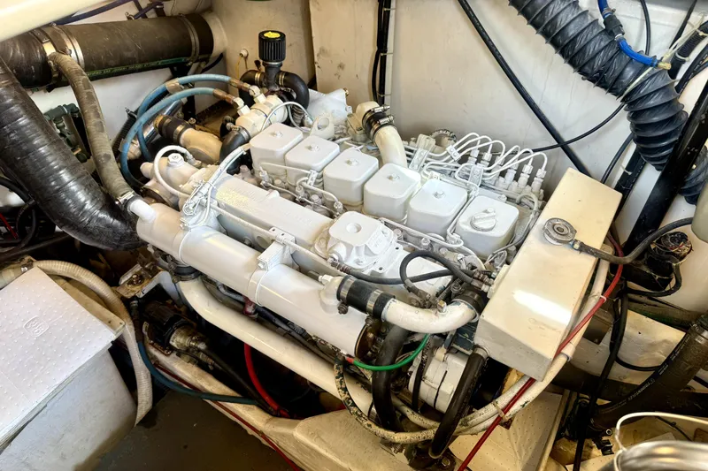 Slide: The Image of Engine compartment of a 1998 Tiara Yachts 3500 Express, showcasing detailed mechanical components. - 38