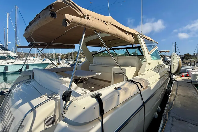 Slide: The Image of 1998 Tiara Yachts 3500 Express docked at marina under clear blue sky. - 5