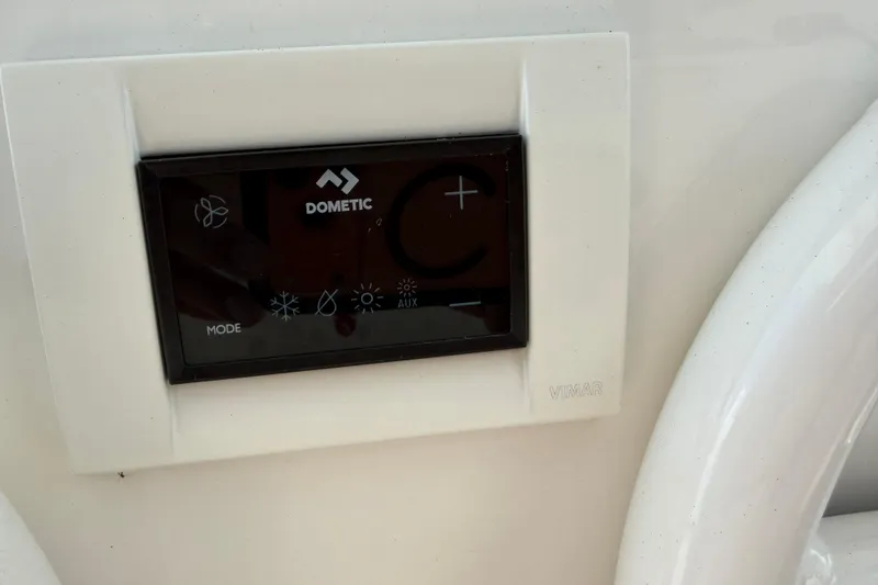 Slide: The Image of Dometic control panel on 2023 Regulator 37 boat, featuring mode and auxiliary settings. - 10