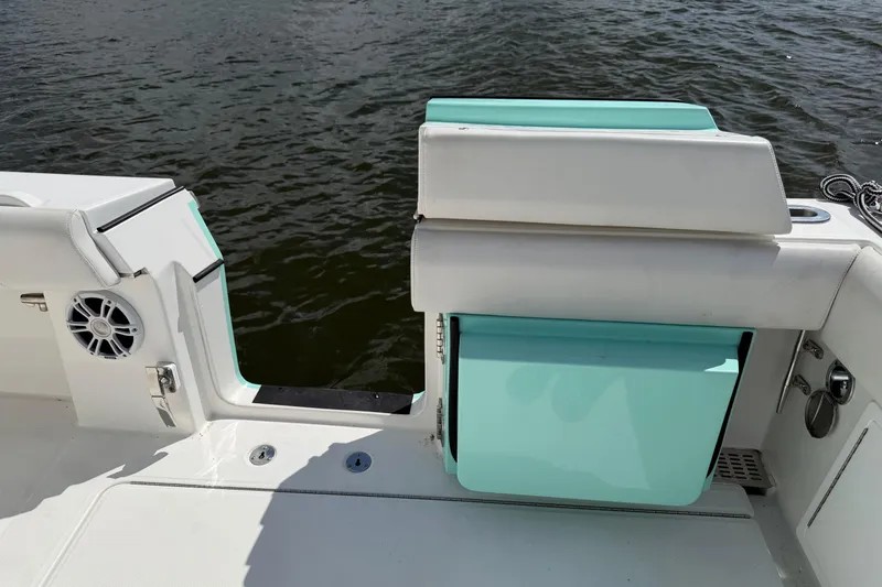 Slide: The Image of 2023 Regulator 37 boat interior with teal accents and water view. - 11