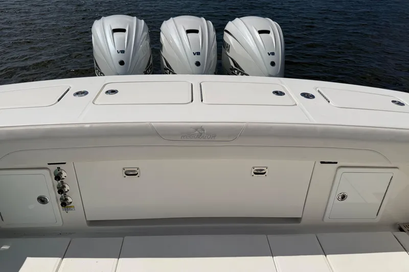 Slide: The Image of 2023 Regulator 37 boat with triple V8 engines, sleek design, and spacious deck. - 16