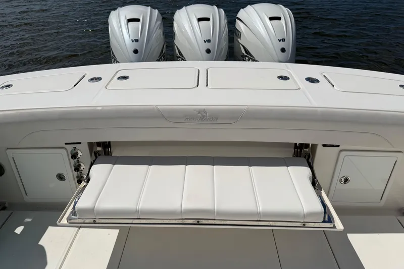 Slide: The Image of 2023 Regulator 37 boat with triple V8 engines and fold-out seating on deck. - 17