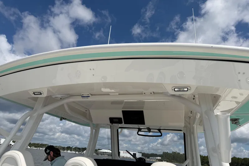Slide: The Image of 2023 Regulator 37 boat with sleek design and modern features under a blue sky. - 20