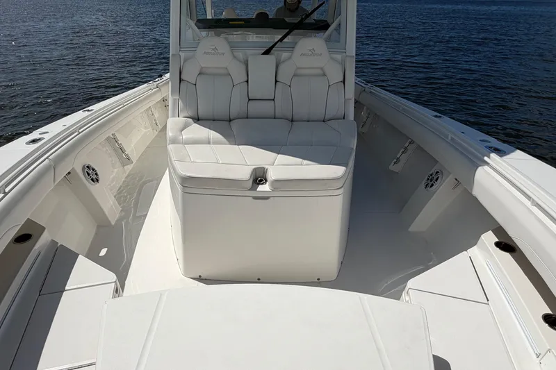 Slide: The Image of 2023 Regulator 37 boat interior with white seating and ocean backdrop. - 24