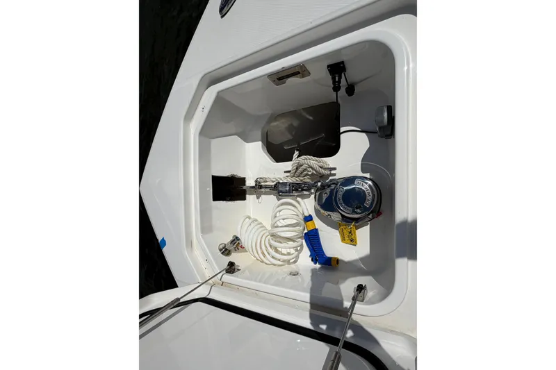 Slide: The Image of Storage compartment of 2023 Regulator 37 boat with coiled hose and equipment. - 25