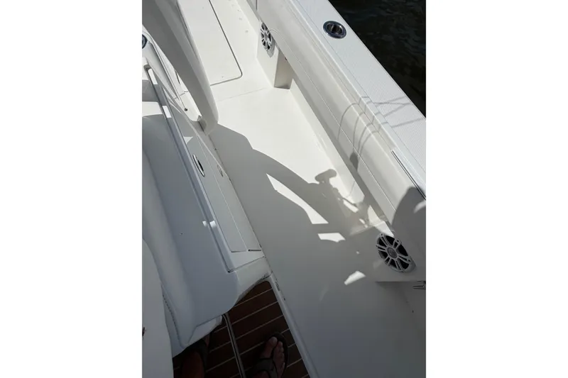 Slide: The Image of 2023 Regulator 37 boat deck with seating and speakers in sunlight. - 27