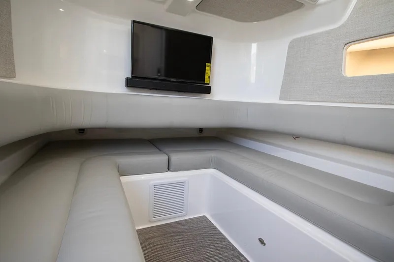 Slide: The Image of 2023 Regulator 37 boat interior with gray seating and mounted TV. - 28