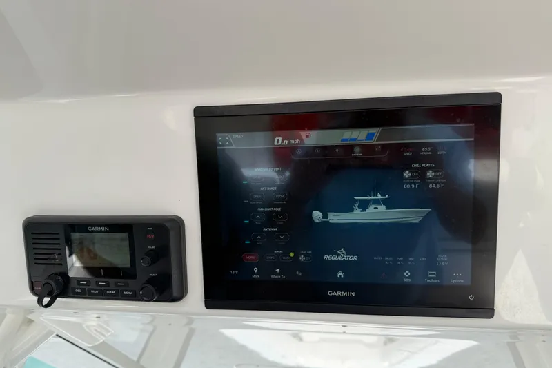 Slide: The Image of Garmin marine display on 2023 Regulator 37 boat dashboard, showing navigation and system controls. - 7