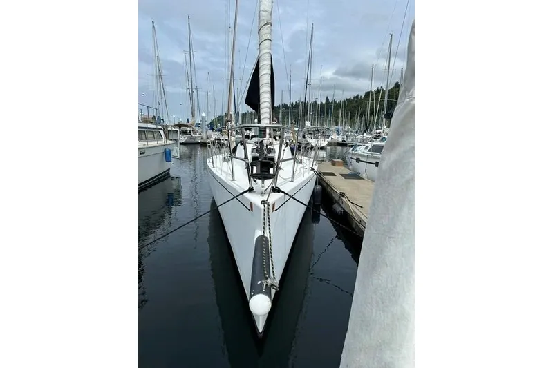 Slide: The Image of Sailboat Bravura B35, 1999 model, docked in a marina with other boats. - 17