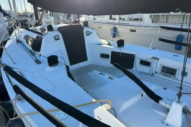 Slide: The Image of Sailboat Bravura B35, 1999 model, docked in marina, featuring spacious cockpit. - 18