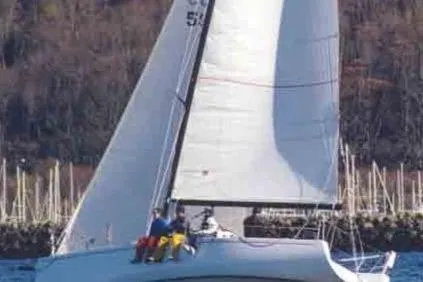 Slide: The Image of Sailboat Bravura B35, 1999 model, sailing with crew on a sunny day. - 2