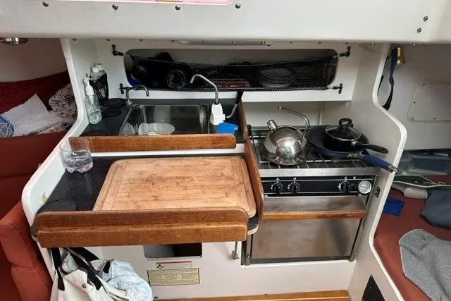 Slide: The Image of Compact kitchen area in a 1999 Bravura B35 boat with stove, sink, and cutting board. - 20