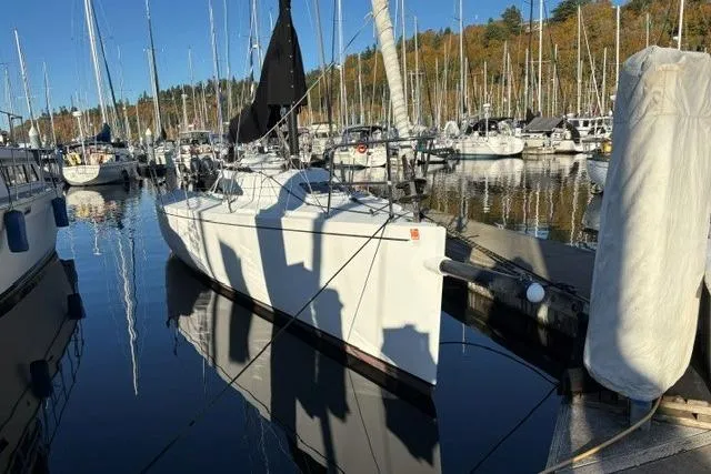 Slide: The Image of Sailboat Bravura B35 (1999) docked in a marina with numerous masts in the background. - 21