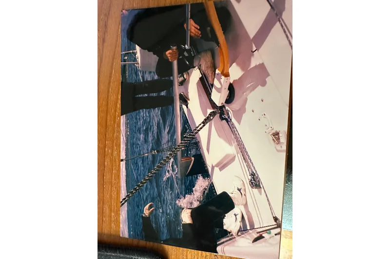 Slide: The Image of Sailing on a Bravura B35 yacht, 1999, with crew managing ropes on deck. - 23