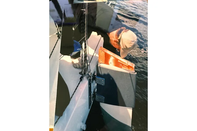 Slide: The Image of Man inspecting Bravura B35 sailboat on water, 1999 model. - 24