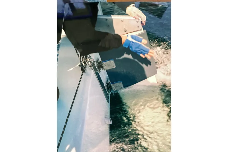Slide: The Image of Person adjusting rudder on Bravura B35 sailboat, 1999 model, in motion on water. - 25