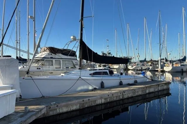 Slide: The Image of 1999 Bravura B35 sailboat docked in a marina, surrounded by other boats. - 4