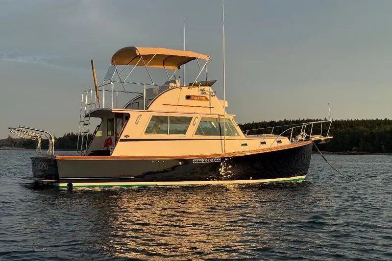 Slide: The Image of Wilbur Weekender 1995 boat on calm water at sunset. - 1