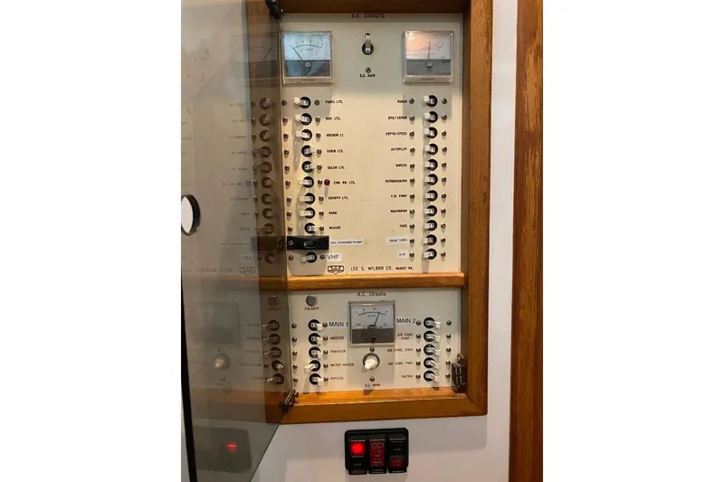 Slide: The Image of Electrical control panel on a 1995 Wilbur Weekender boat, featuring various switches and meters. - 18