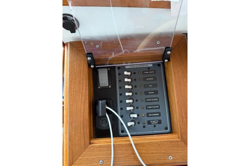 Slide: The Image of Electrical panel of a 1995 Wilbur Weekender boat with labeled switches and USB charger. - 19
