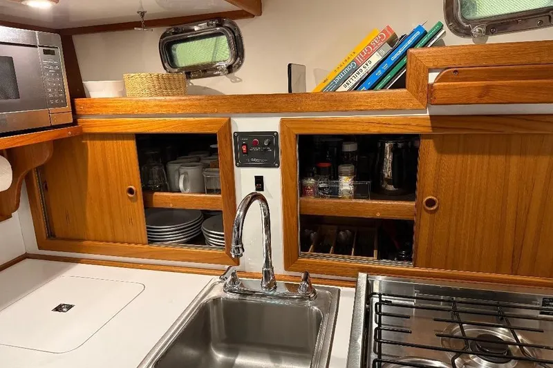 Slide: The Image of Galley area of a 1995 Wilbur Weekender yacht with wooden cabinets. - 22