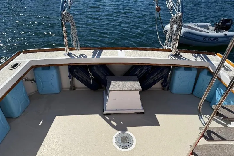 Slide: The Image of 1995 Wilbur Weekender boat deck with storage containers and ropes, docked near water. - 3