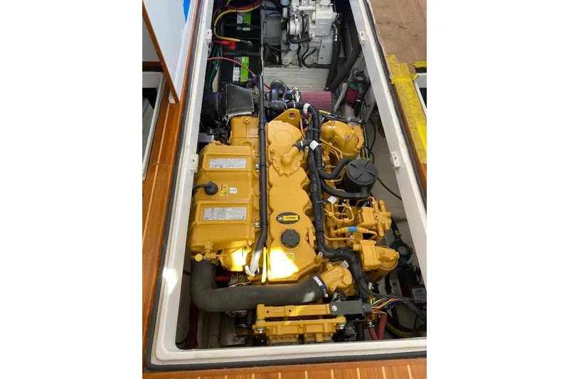 Slide: The Image of Engine compartment of a 1995 Wilbur Weekender boat, featuring a yellow engine. - 33