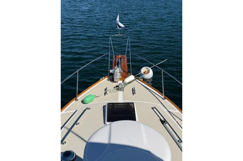 Slide: The Image of Bow view of 1995 Wilbur Weekender boat on calm water. - 5