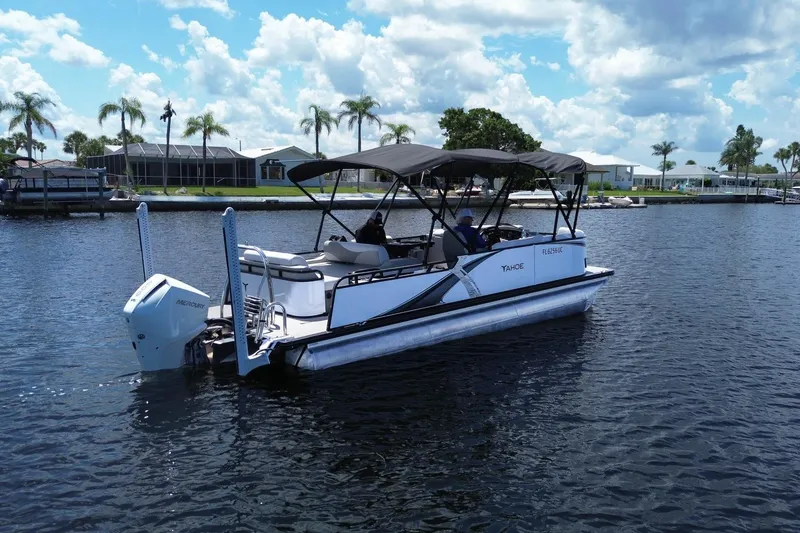 Slide: The Image of 2025 Tahoe Pontoon LTZ 23 on a sunny lake, featuring a Mercury outboard motor. - 3