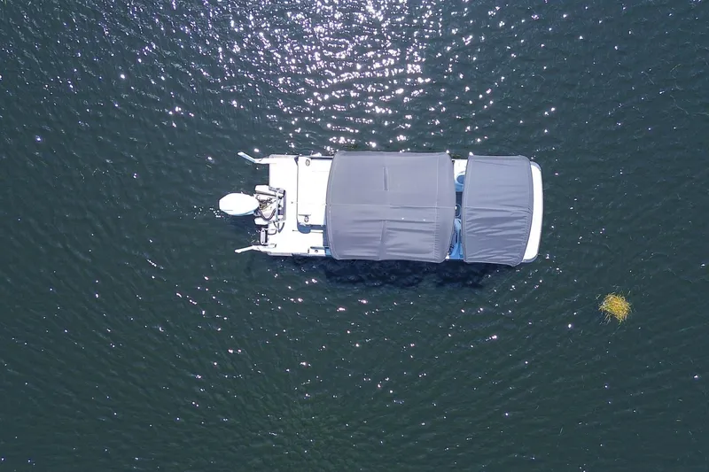 Slide: The Image of Aerial view of 2025 Tahoe Pontoon LTZ 23 on shimmering water. - 4