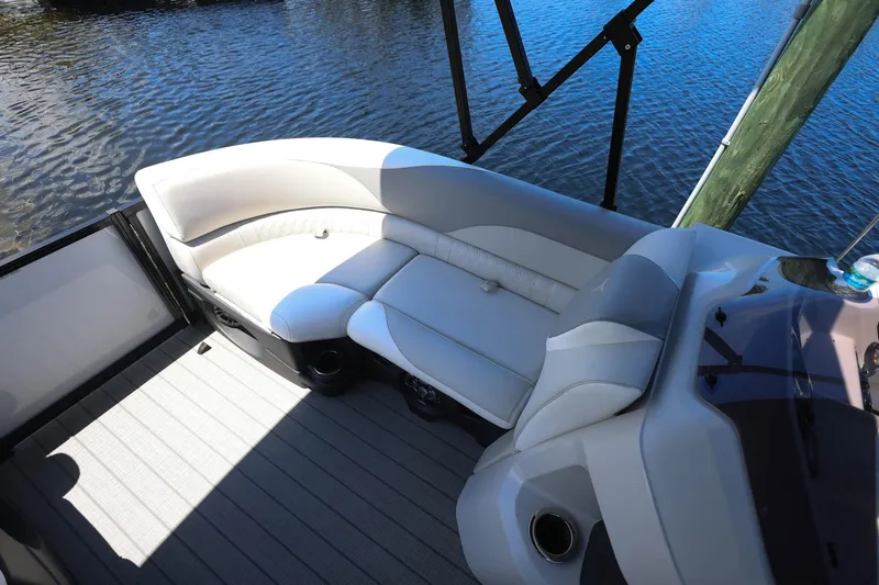 Slide: The Image of Luxurious seating on 2025 Tahoe Pontoon LTZ 23, overlooking serene water. - 7