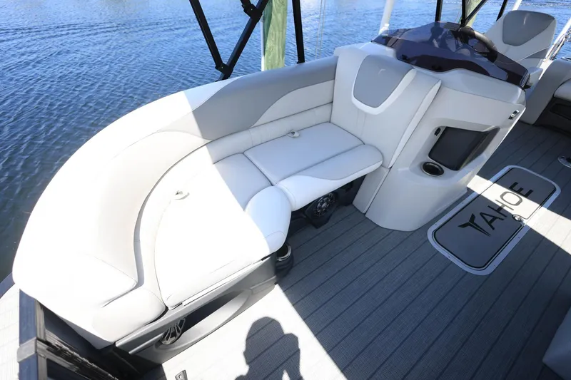 Slide: The Image of 2025 Tahoe Pontoon LTZ 23 interior with plush seating and modern design on the water. - 9