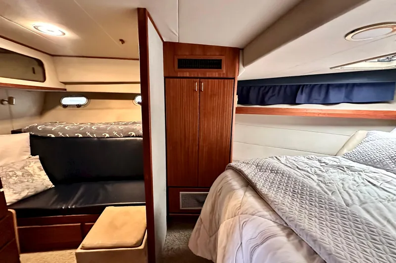 Slide: The Image of Cozy interior of 1993 Bayliner 4588 Pilothouse with bed, seating, and wooden cabinetry. - 14