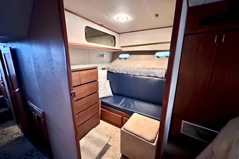 Slide: The Image of 1993 Bayliner 4588 Pilothouse interior cabin with seating, storage, and nautical decor. - 15