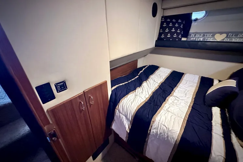 Slide: The Image of Cozy bedroom interior of 1993 Bayliner 4588 Pilothouse with nautical-themed decor. - 19