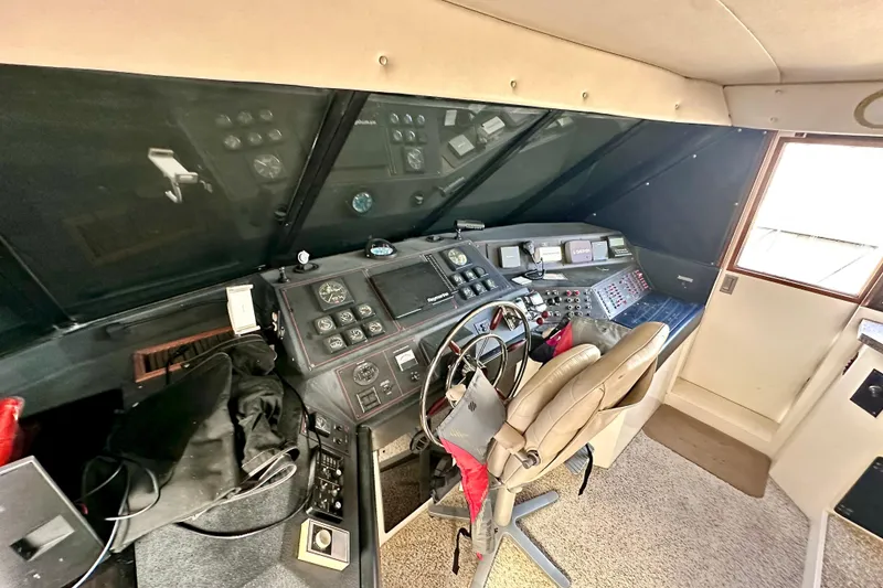Slide: The Image of Interior view of 1993 Bayliner 4588 Pilothouse helm with navigation controls and captain's chair. - 24