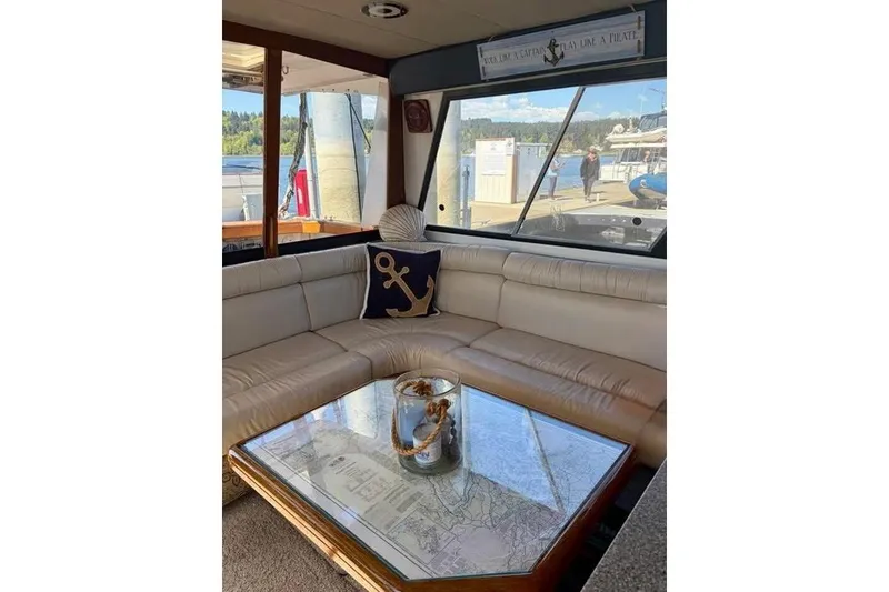 Slide: The Image of Interior of 1993 Bayliner 4588 Pilothouse with nautical decor and waterfront view. - 4