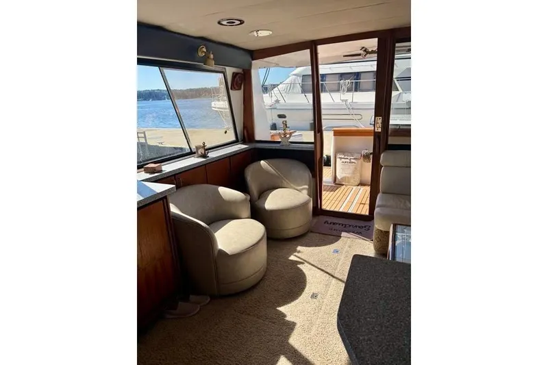 Slide: The Image of Interior of 1993 Bayliner 4588 Pilothouse yacht with cozy seating and waterfront view. - 6