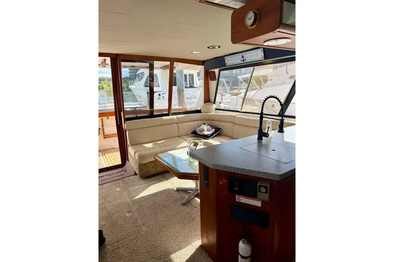 Slide: The Image of Interior of 1993 Bayliner 4588 Pilothouse yacht with cozy seating and modern amenities. - 7