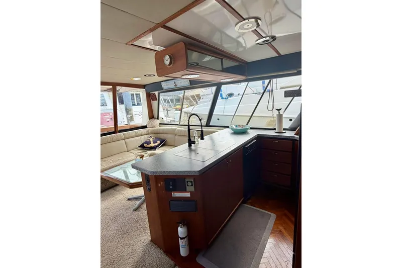 Slide: The Image of Interior of 1993 Bayliner 4588 Pilothouse yacht with modern kitchen and seating area. - 8