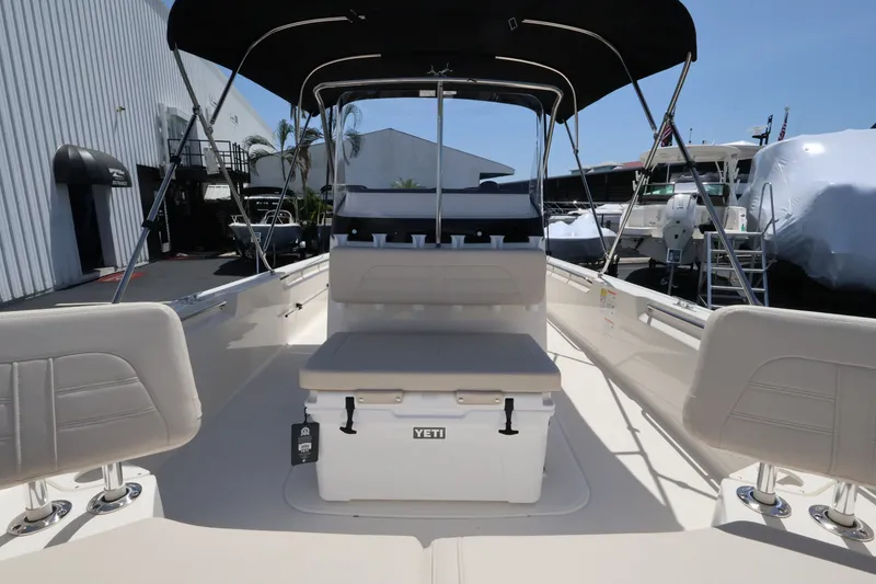 Slide: The Image of The image shows the cockpit of a Boston Whaler 210 Montauk with seating and a Yeti cooler. - 22