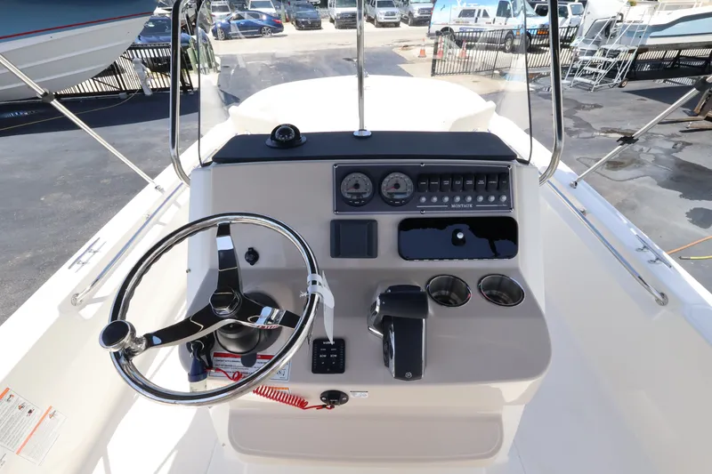 Slide: The Image of The image shows the cockpit of a 2027 Boston Whaler 210 Montauk with a modern helm. - 16
