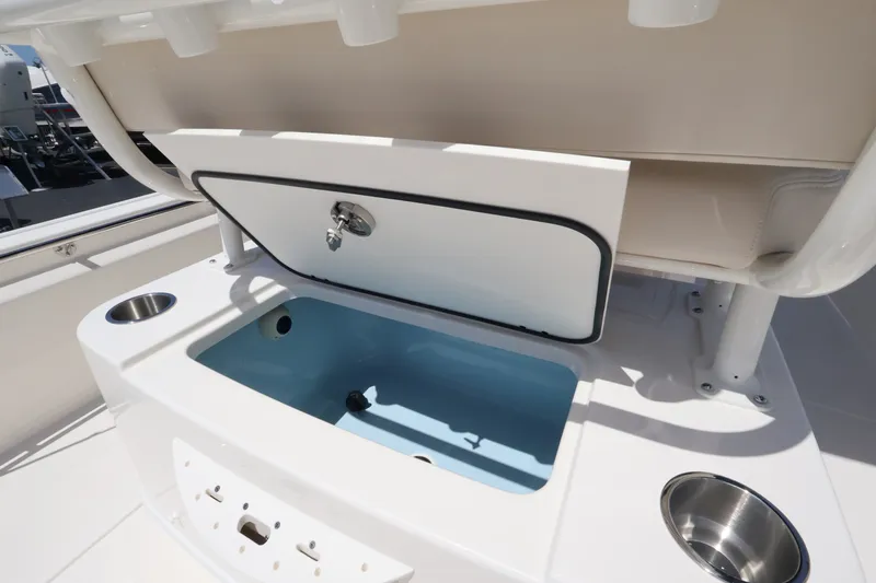 Slide: The Image of The image shows an open storage compartment on a Boston Whaler 210 Montauk boat. - 14