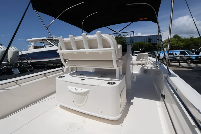 Slide: The Image of The image shows the deck of a Boston Whaler 210 Montauk with a sun-shading bimini top. - 13