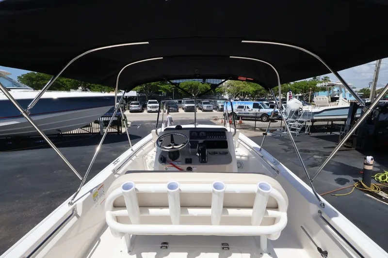 Slide: The Image of The image shows the cockpit of a Boston Whaler 210 Montauk with a black Bimini top. - 15