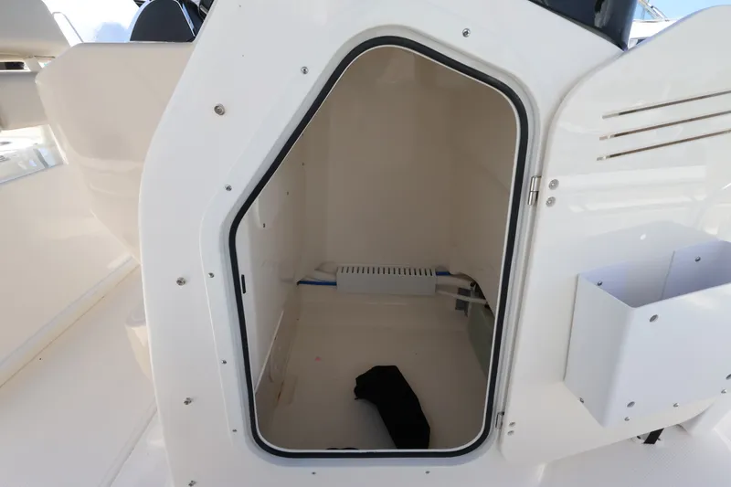 Slide: The Image of An open storage compartment on a 2027 Boston Whaler 210 Montauk boat. - 19
