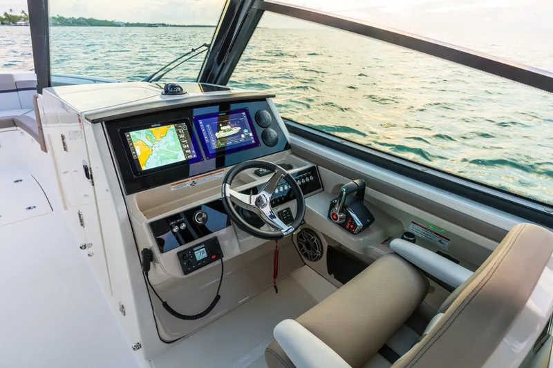 Slide: The Image of The cockpit of the 2027 Boston Whaler 330 Vantage features modern navigation systems and a comfortable helm. - 24