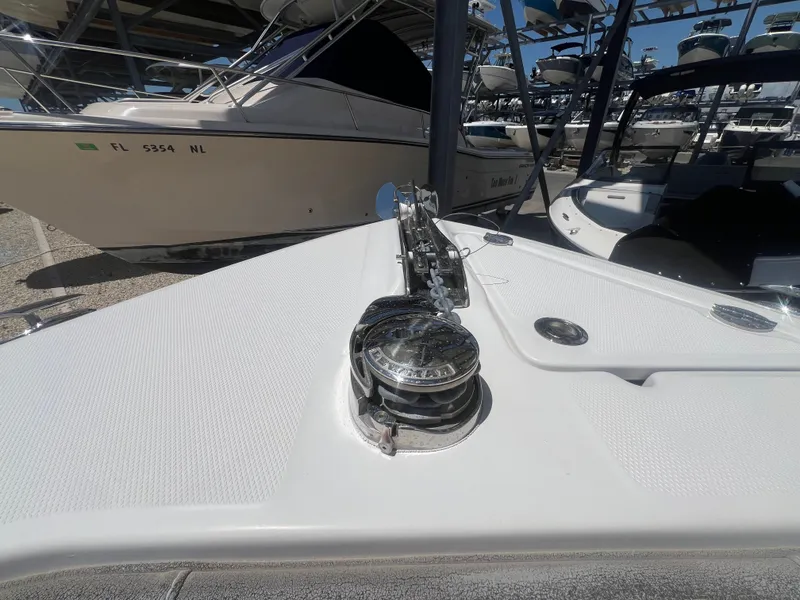 Slide: The Image of Bow of a boat with anchor windlass and surrounding boats in the background. - 25